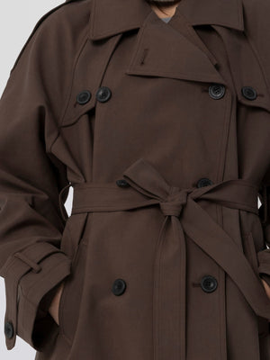 Brun trenchcoat med knapper og bælte, perfekt til efteråret. MEOTINE tilføjer stil og komfort til din garderobe.
